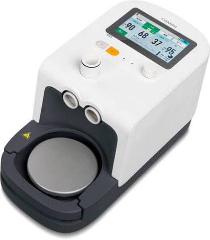 White medical respiratory device with a digital display screen and a front-facing circular heating plate.
